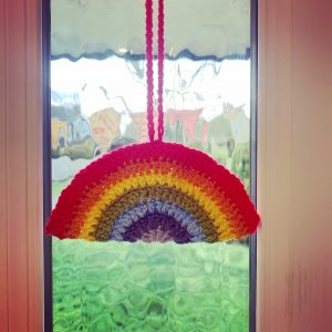 crochet rainbow hanging in Rosie's front door window
