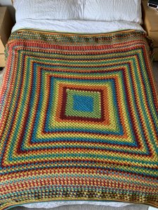 A giant granny square in rainbow colours
