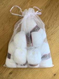 A bag full of white balls of yarn - sky blanket march update